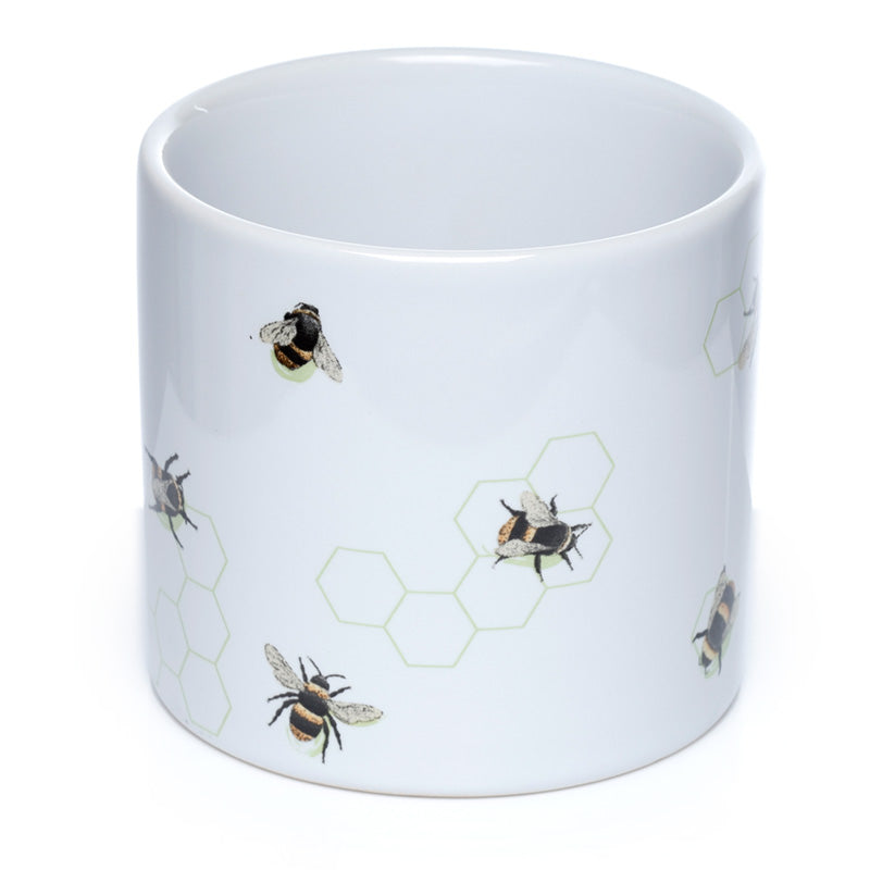 White mug with bee and honeycomb pattern on a white background