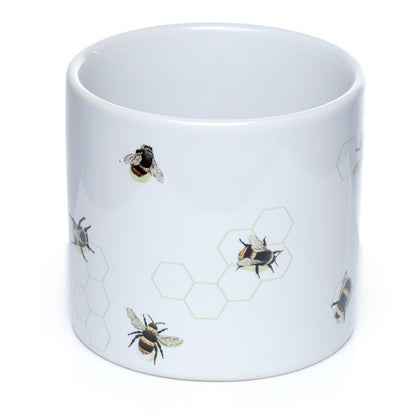 White mug with bee and honeycomb pattern on a white background