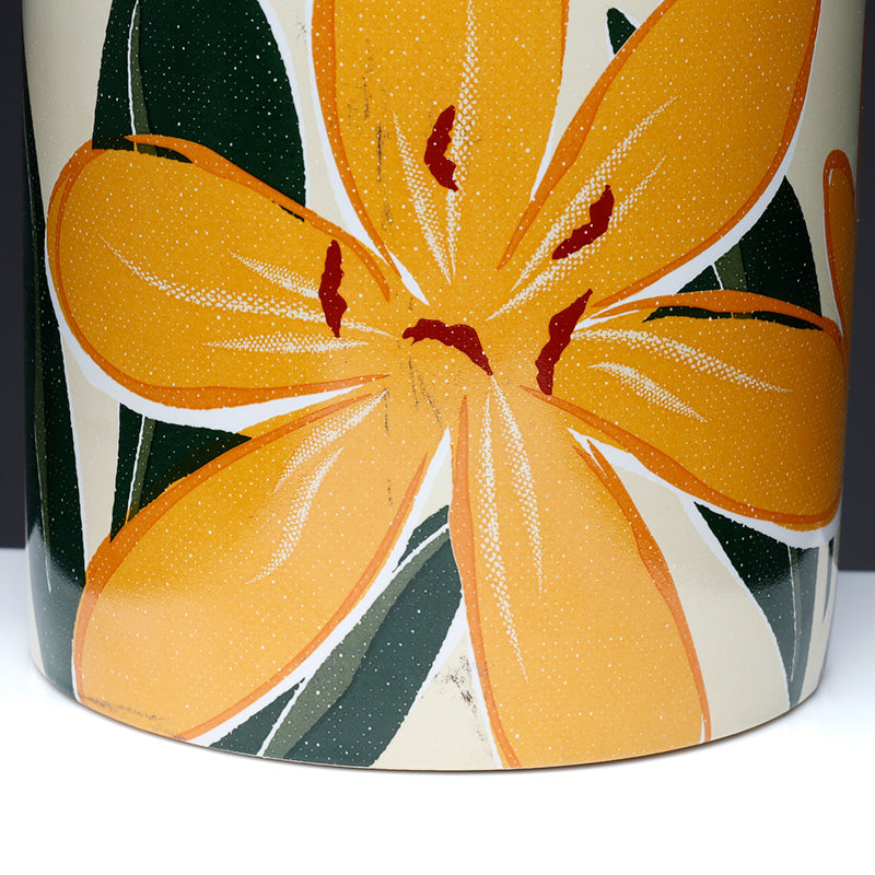 Ceramic vase with orange floral design on a white background