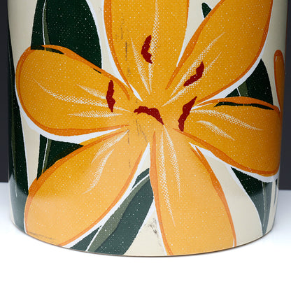 Ceramic vase with orange floral design on a white background