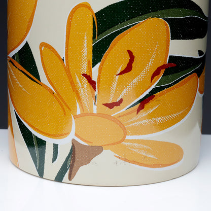 Ceramic vase with yellow floral design on a white background
