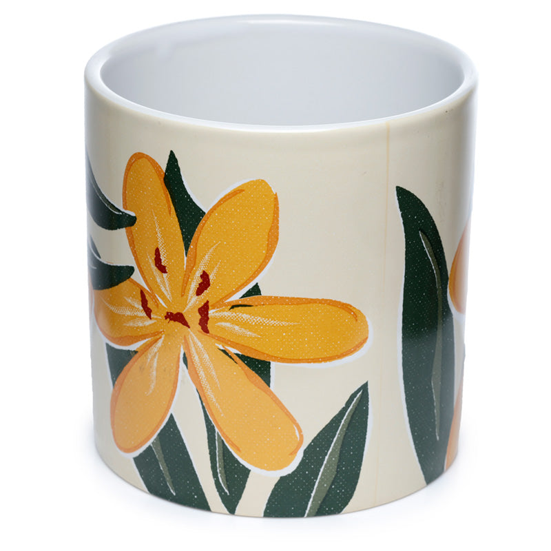 White mug with a yellow flower design on a white background