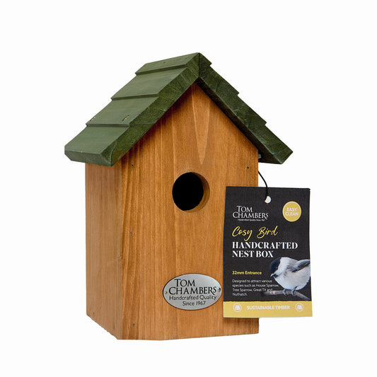 Wooden birdhouse with green roof and 'Tom Chambers' label on a white background