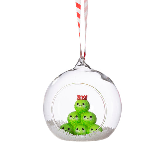 Clear Christmas ornament with green characters inside on a white background