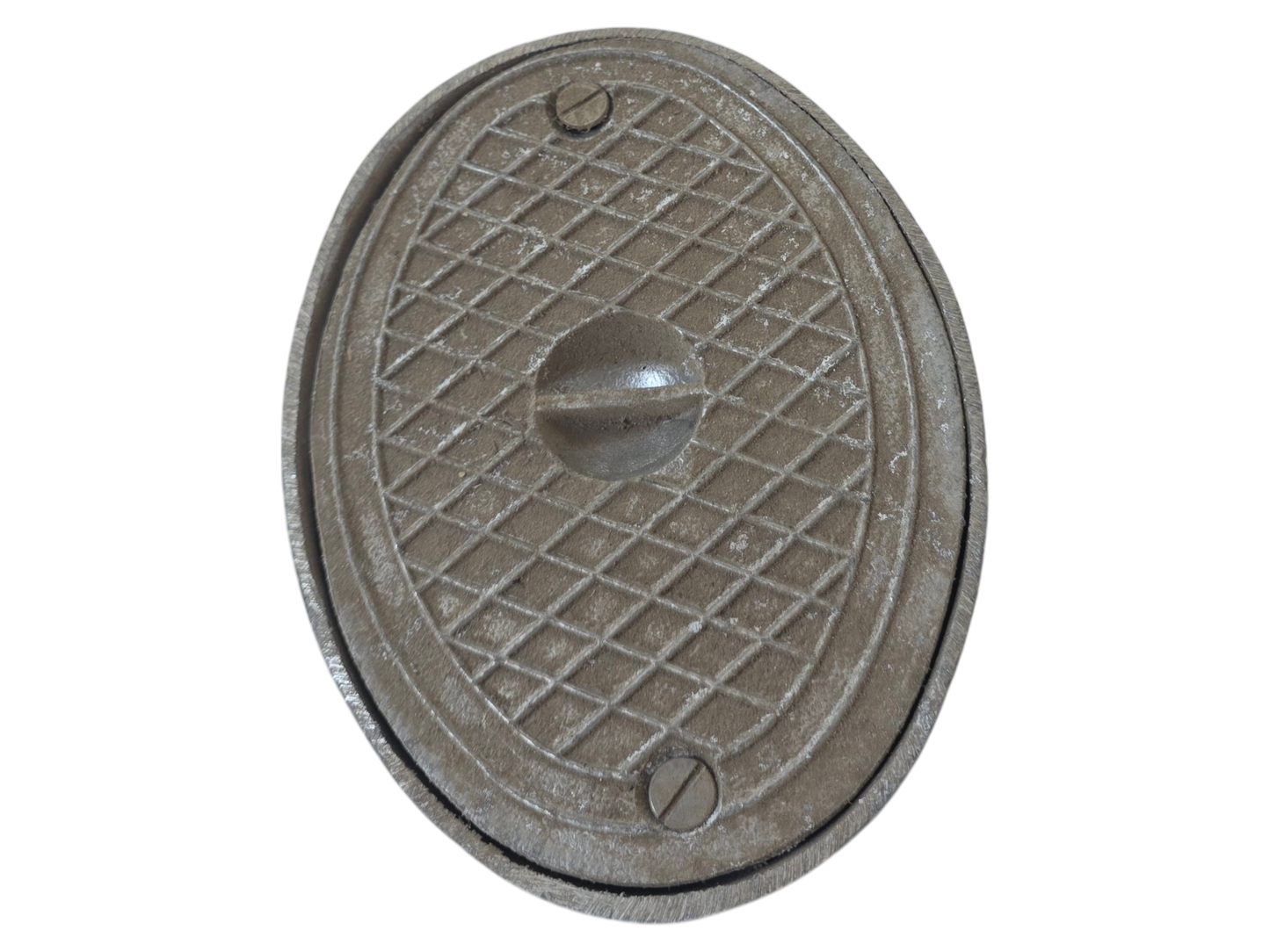 An oval cast iron manhole cover with a textured diamond grid pattern and a central protruding handle, isolated on a white background.