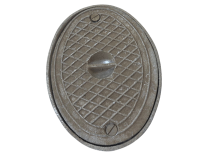 An oval cast iron manhole cover with a textured diamond grid pattern and a central protruding handle, isolated on a white background.