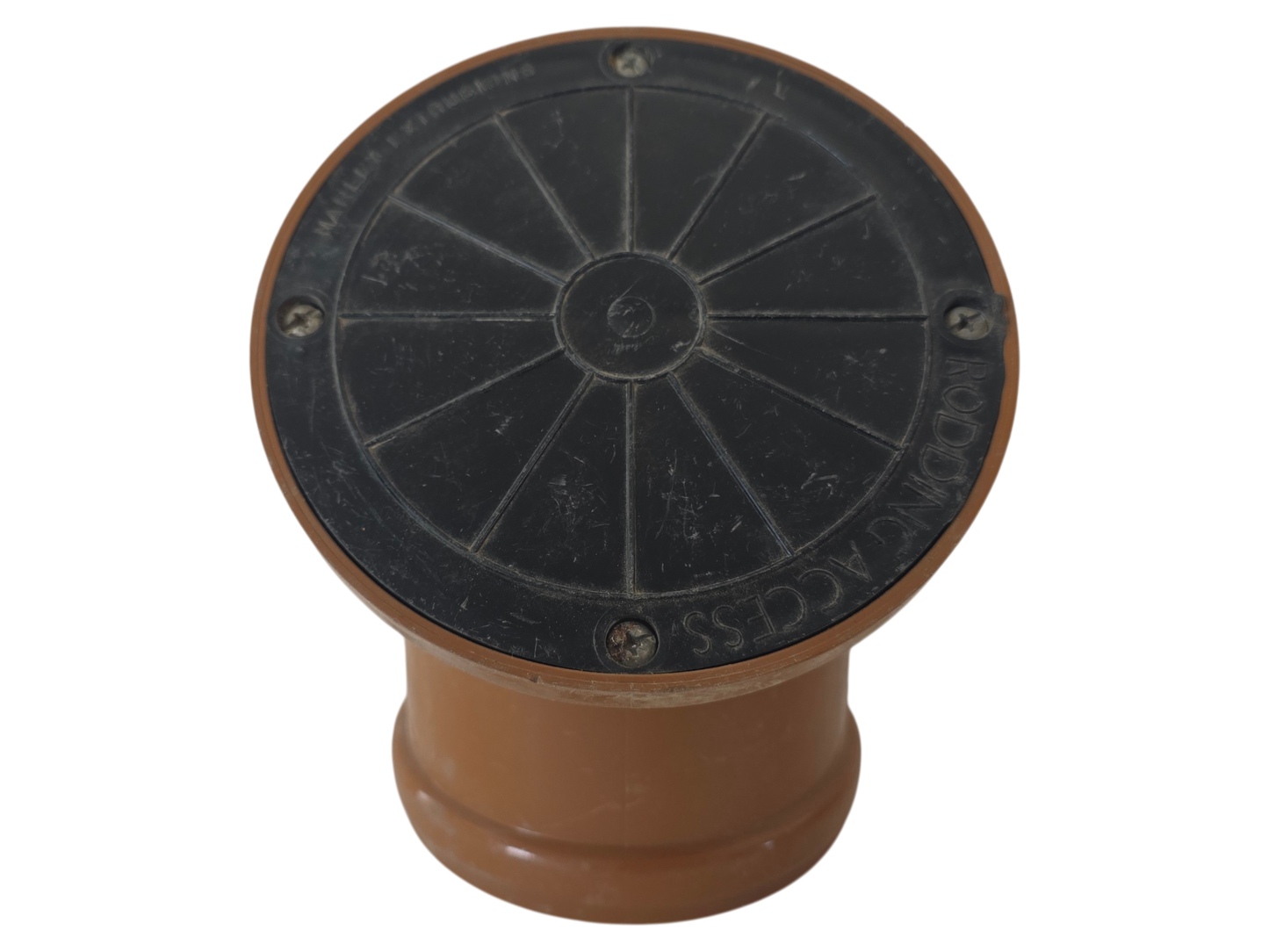 A circular black metal access cover with a brown plastic base, isolated on a white background.