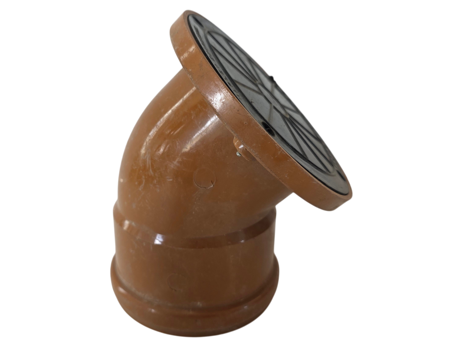 A terracotta clay downspout elbow fitting with a circular black metal grate cover on the top, isolated on a white background.
