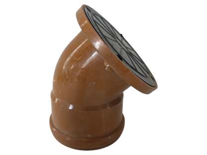 A terracotta clay downspout elbow fitting with a circular black metal grate cover on the top, isolated on a white background.