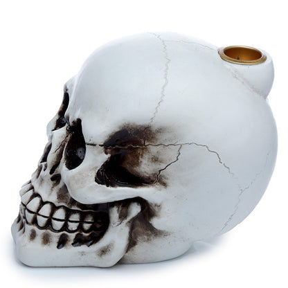 Skull-shaped ceramic pipe on a white background