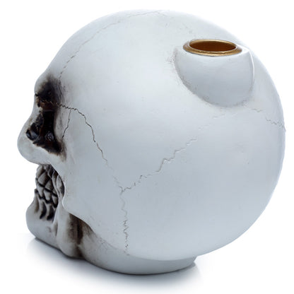 White marble-textured skull-shaped object with a gold accent on a white background