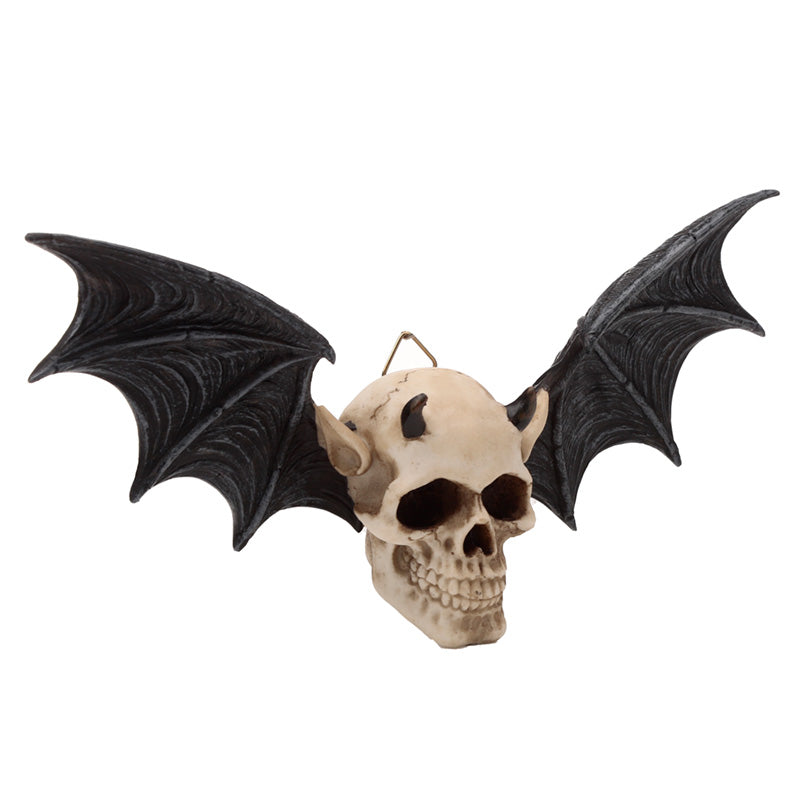 Wall plaque in the shape of a devil's skull with bat wings on a white background