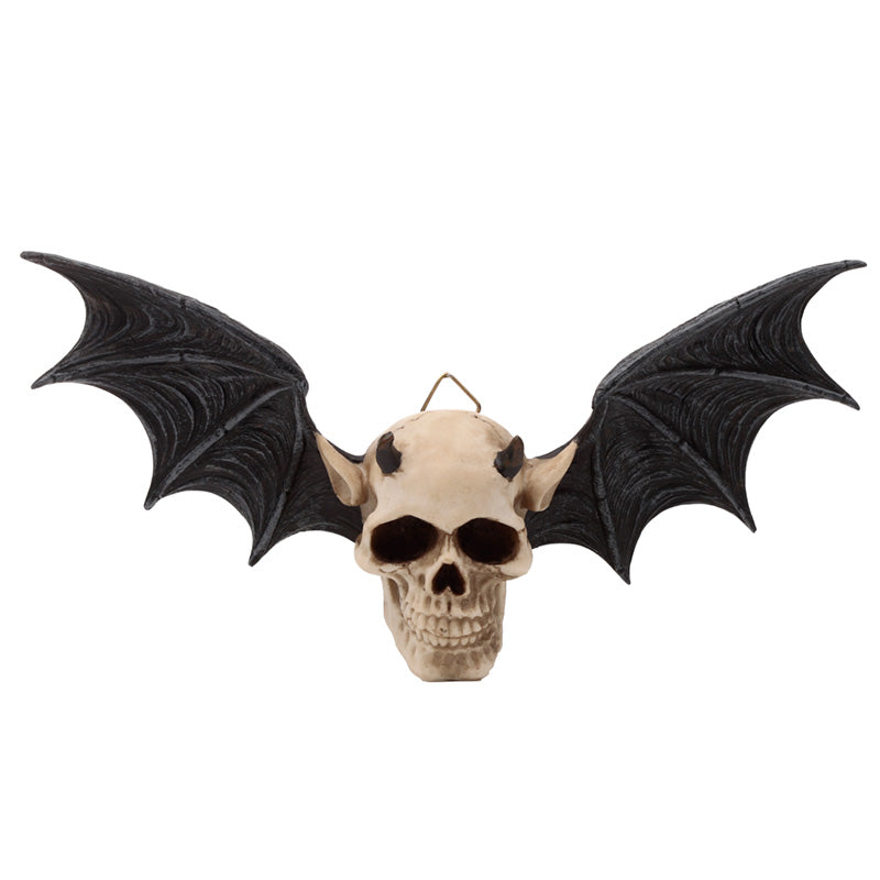 Wall plaque in the shape of a devil's skull with bat wings on a white background