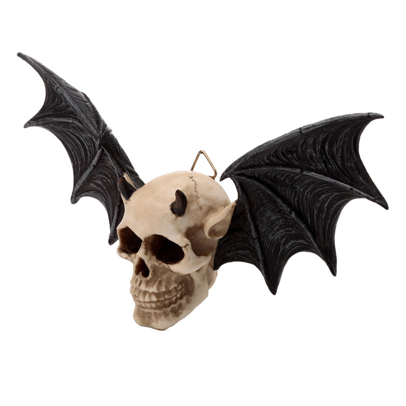 Wall plaque in the shape of a devil's skull with bat wings on a white background