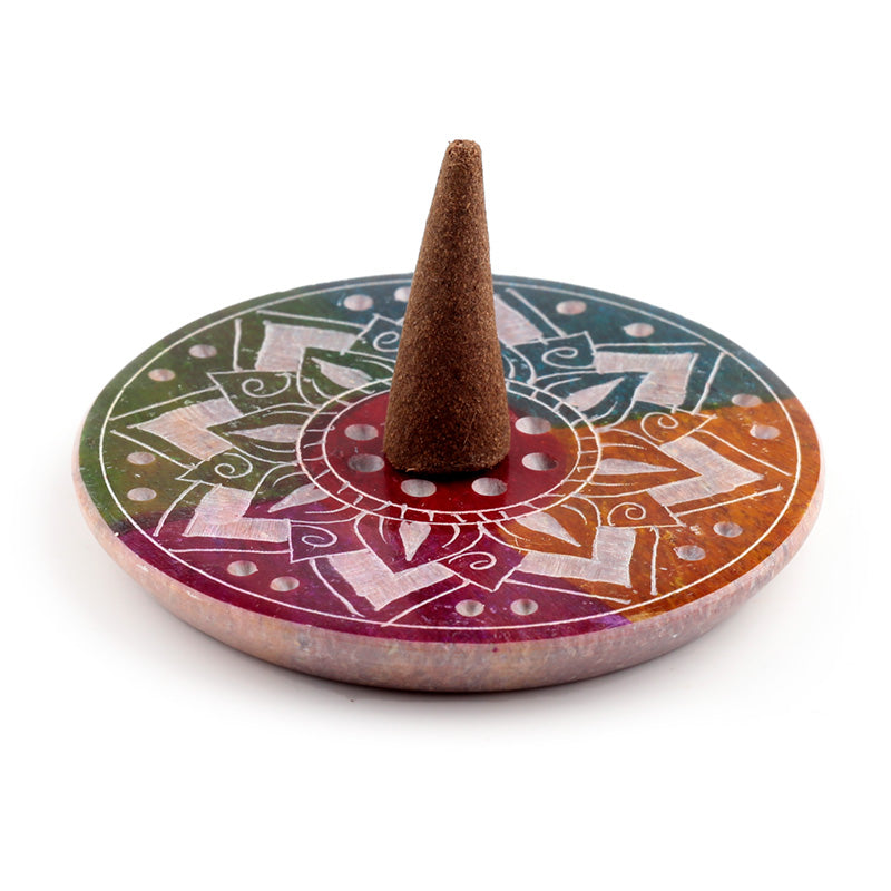 Decorative incense burner with a cone of incense on a white background