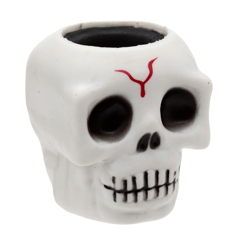 Skull-shaped container with a red design on a white background