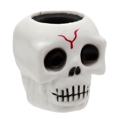 Skull-shaped container with a red design on a white background