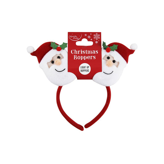Christmas-themed headbands with Santa faces and a packaging label on a white background