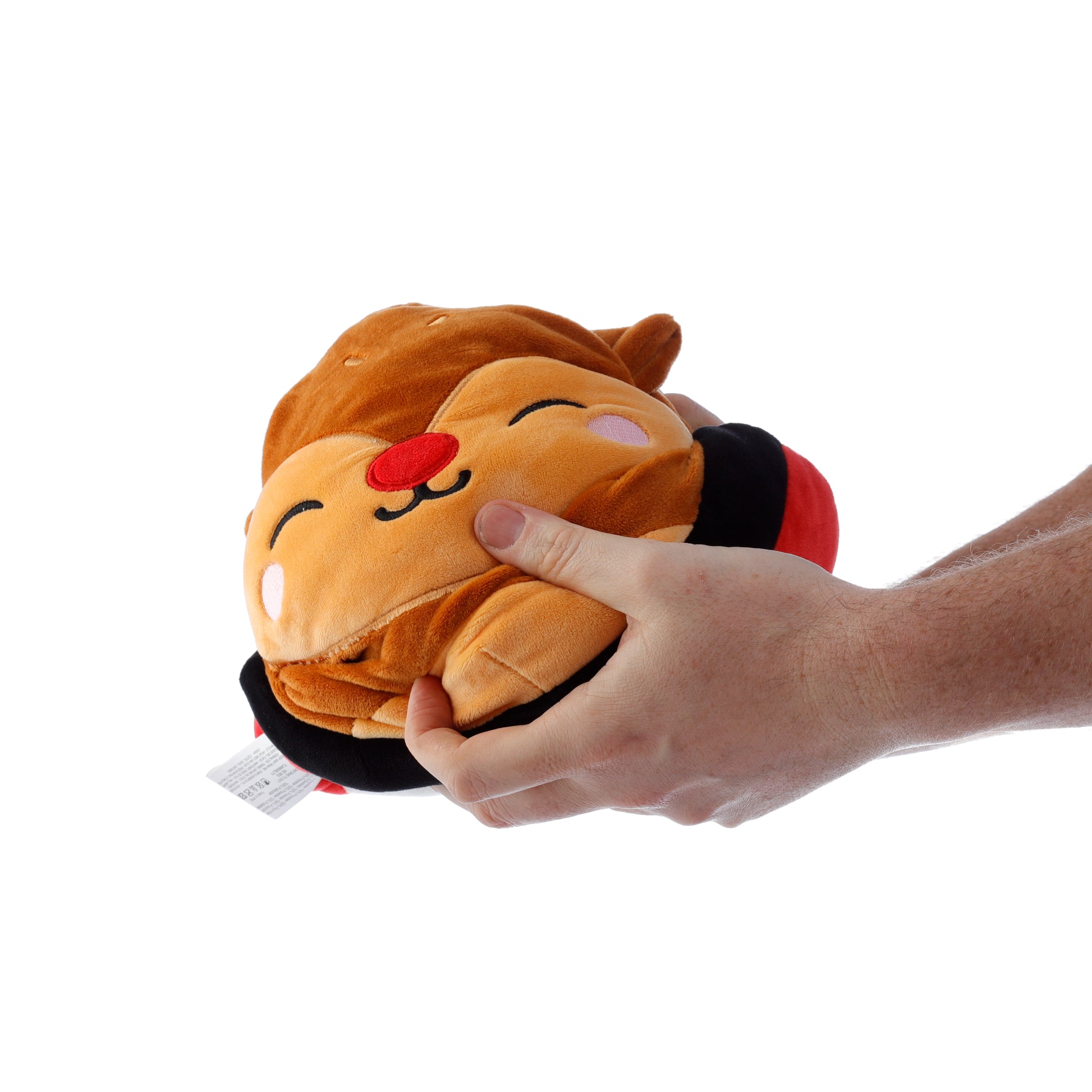 Plush toy resembling a cartoon character being held by a hand on a white background