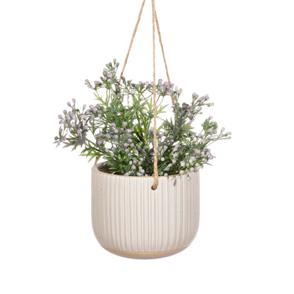 Hanging planter with greenery on a white background