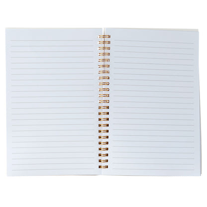 Open notebook with lined pages and gold spiral binding on a white background