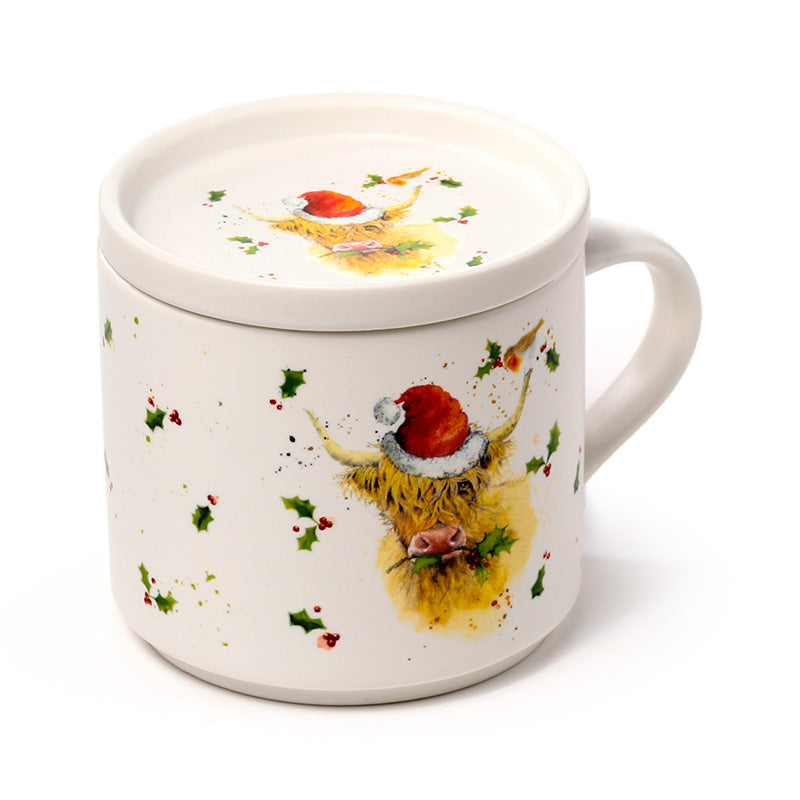 Mug with Christmas highland cow design on a white background