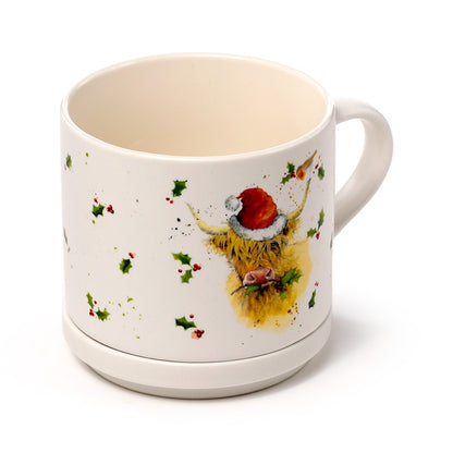 Mug with Christmas highland cow design on a white background