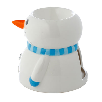 White mug shaped like a snowman with an orange carrot nose and blue scarf on a white background