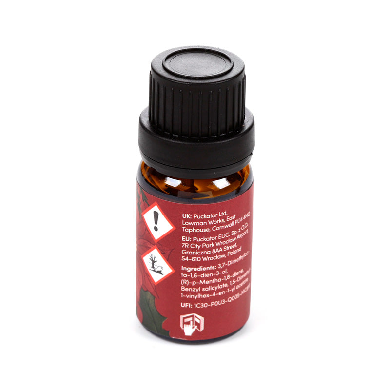 Bottle of Christmas themed fragrance oil on a white background