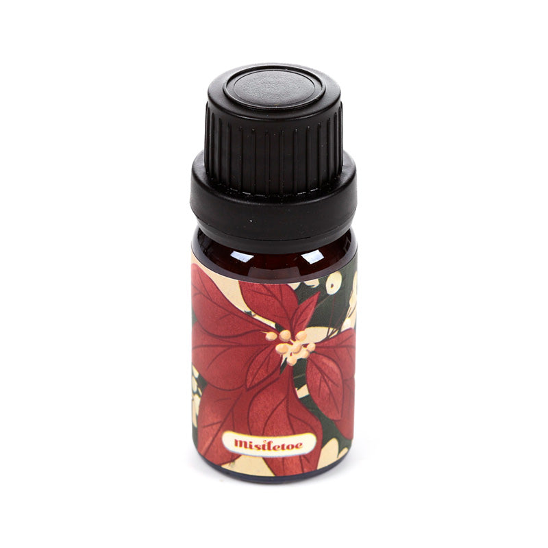 Bottle of Christmas themed fragrance oil on a white background