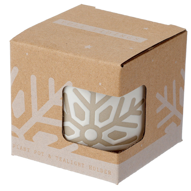 Kraft paper box with a plant pot and tealight holder inside, featuring snowflake designs.