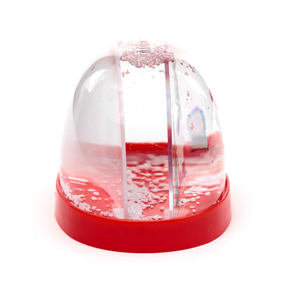 Small snow globe with a red base on a white background