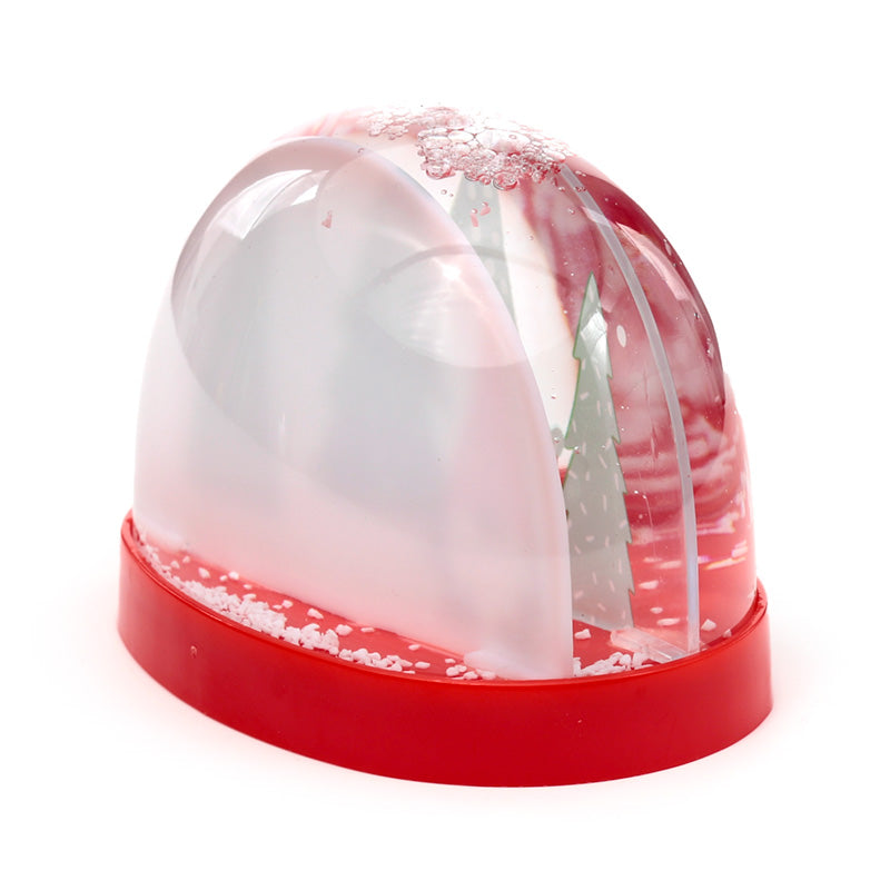 Red snow globe with a white Christmas tree inside on a white background