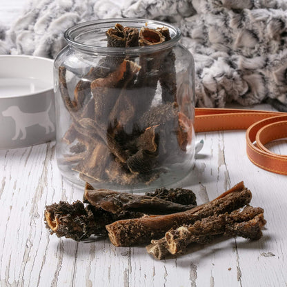Hollings Tripe Sticks in a glass jar on a table