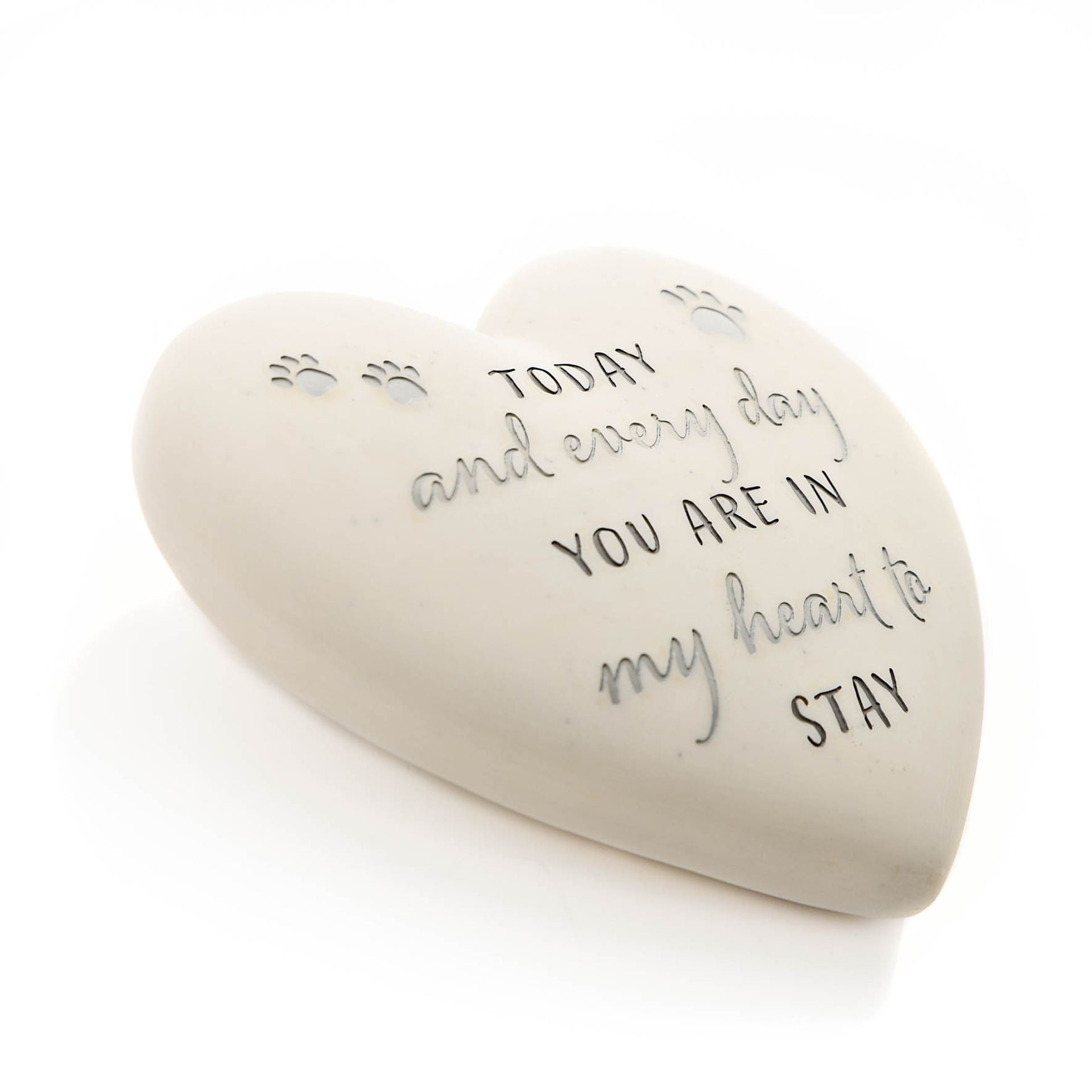 Heart-shaped stone with engraved text on a white background