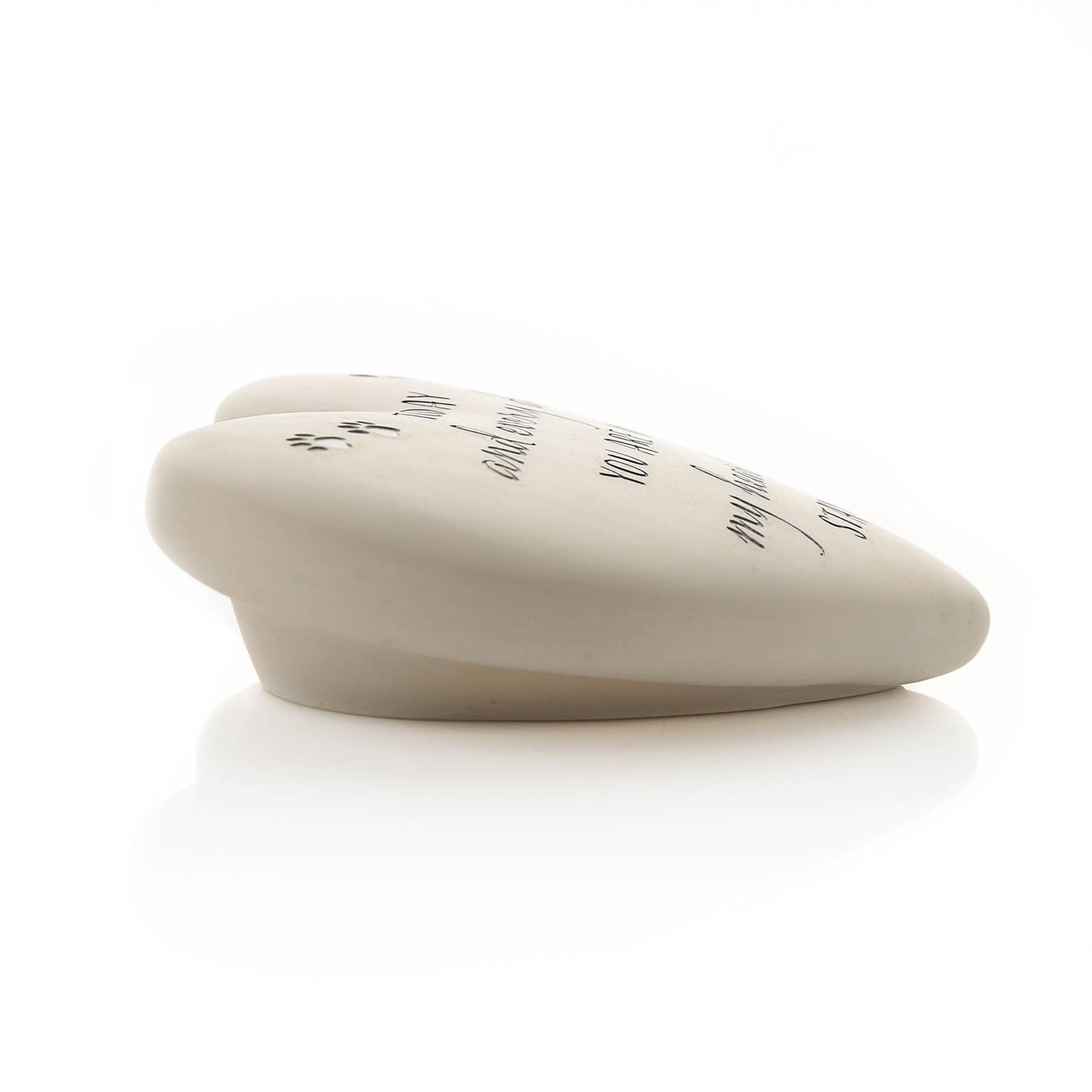 Heart-shaped stone with engraved text on a white background