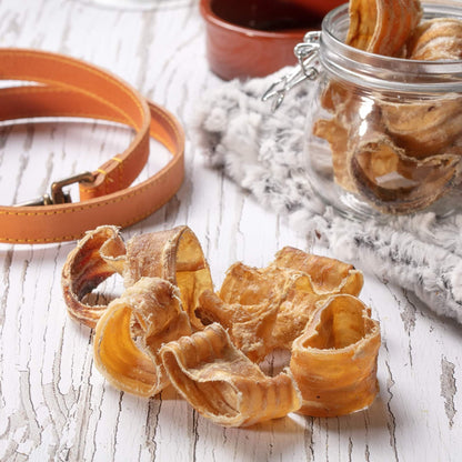 Hollings Beef Curls 100g on a table next to a glass jar and a dog lead
