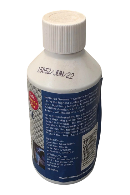 A white plastic bottle of Bermuda Ornament Colour by WMS CLP, showing the back label with product details and handling instructions, on a white background.