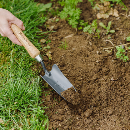 Kent & Stowe Carbon Steel Hand Transplanting Trowel digging some soil