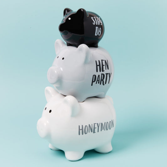 Three piggy banks stacked on a light blue background, with 'HEN PARTY', 'STAG DO', and 'HONEYMOON' text.