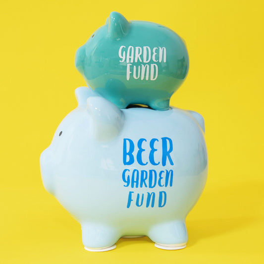 Two piggy banks stacked on top of each other with 'Garden Fund' and 'Beer Garden Fund' text on a yellow background.