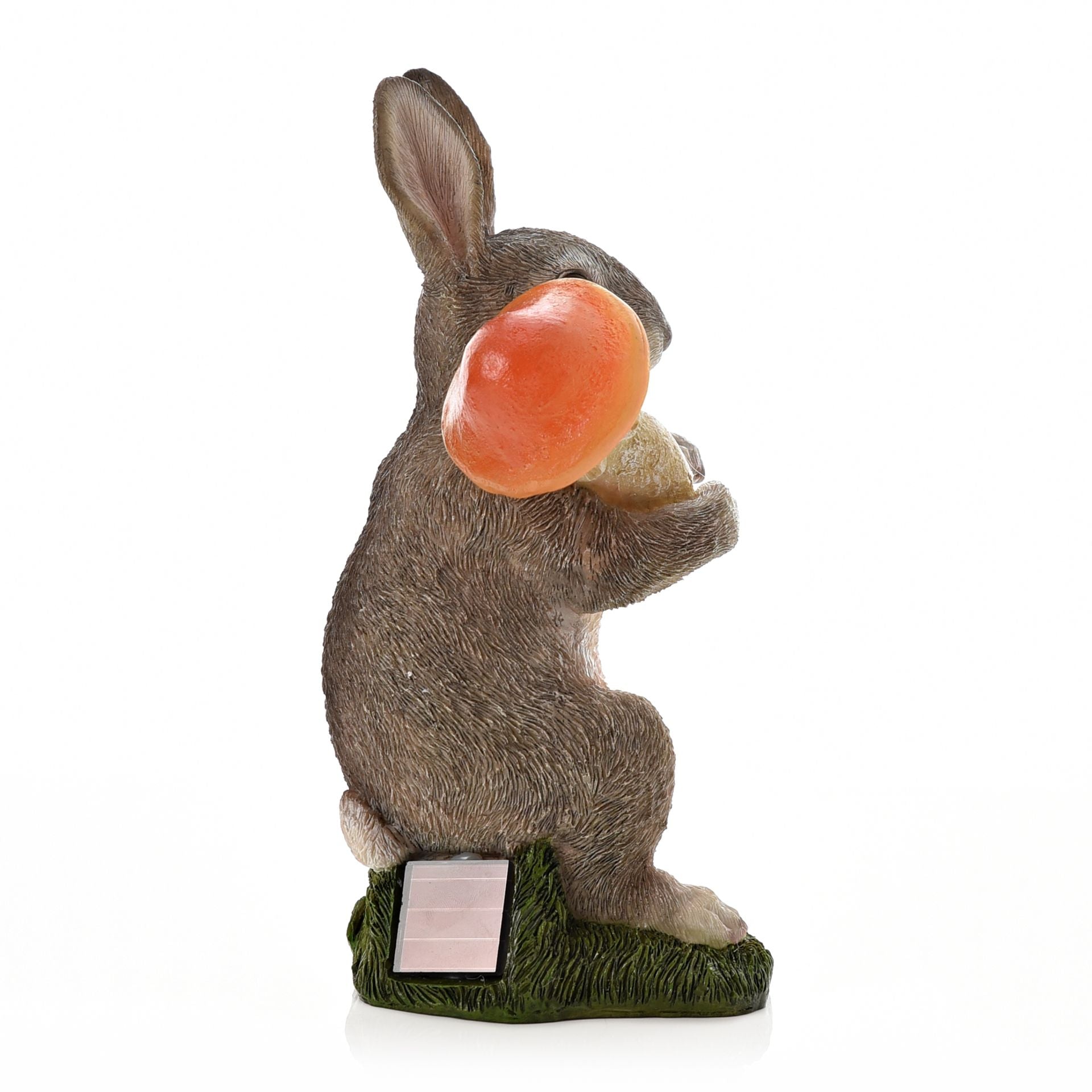 Statue of a rabbit with a carrot on a white background