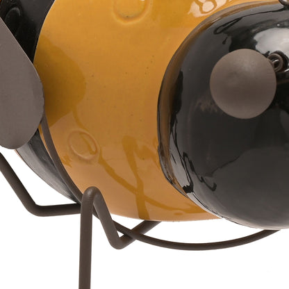 Close-up of a yellow and black lamp with a white background