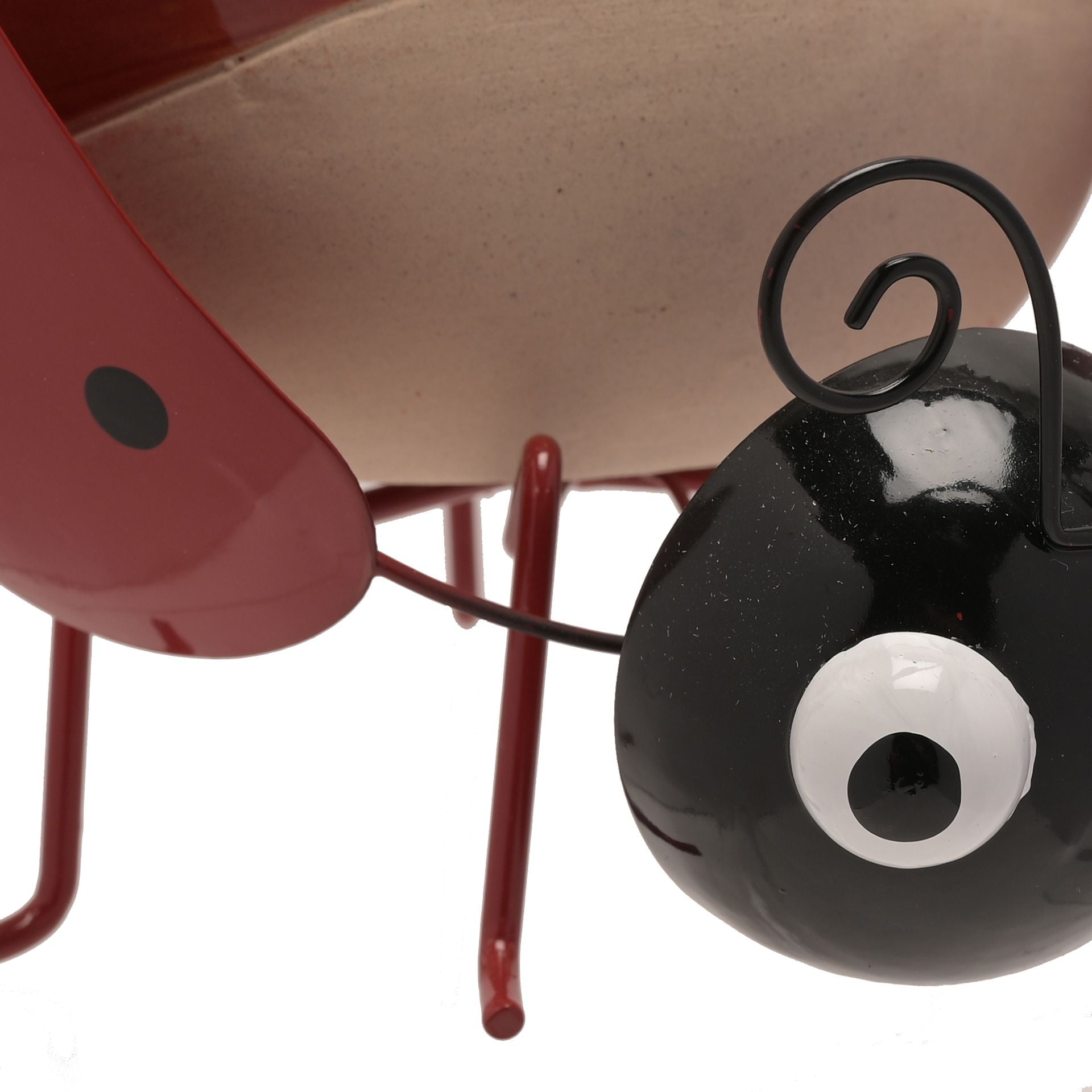 Close-up of a red and black ladybug-shaped object on a white background