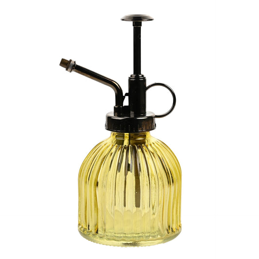 Yellow glass bottle with black metal nozzle on a white background