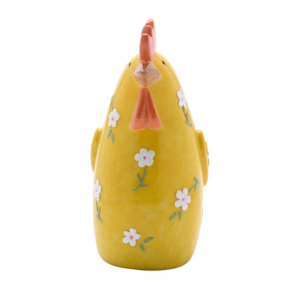 Yellow ceramic chicken with floral patterns on a white background