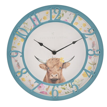 Wall clock with a cow illustration and floral design on a white background