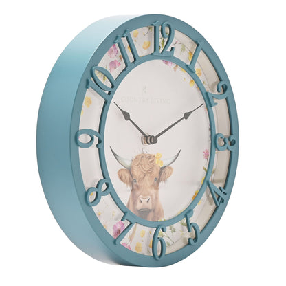 Wall clock with a cow illustration and floral design on a white background