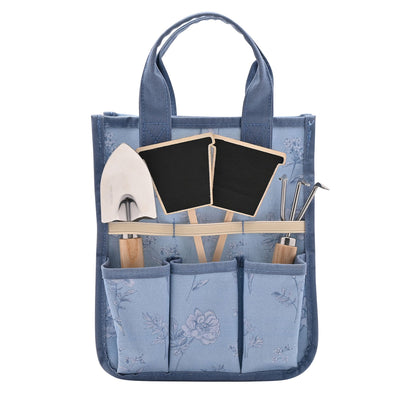 Blue gardening tote bag with tools and plants on a white background
