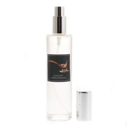 Clear spray bottle labeled 'Rosehip & Birchwood' on a white background